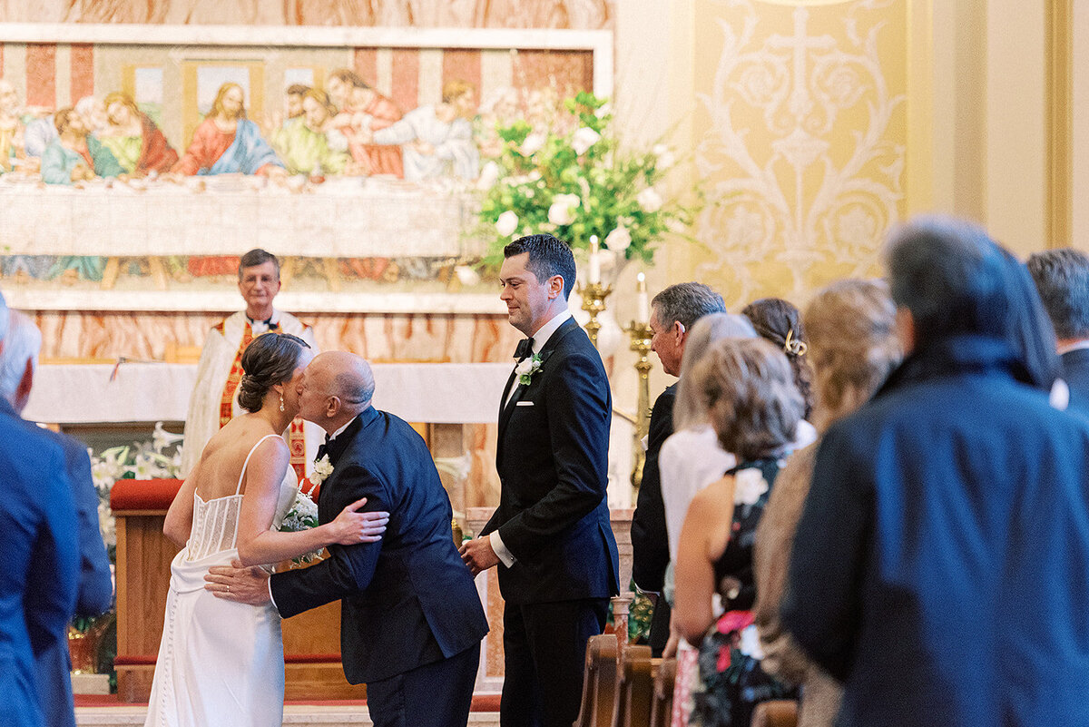 assumption-church-father-kissing-bride-ceremony-chicago-hbicweddings