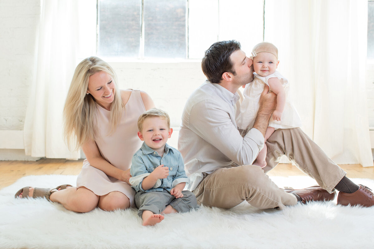family-on-fluffy-white-rug