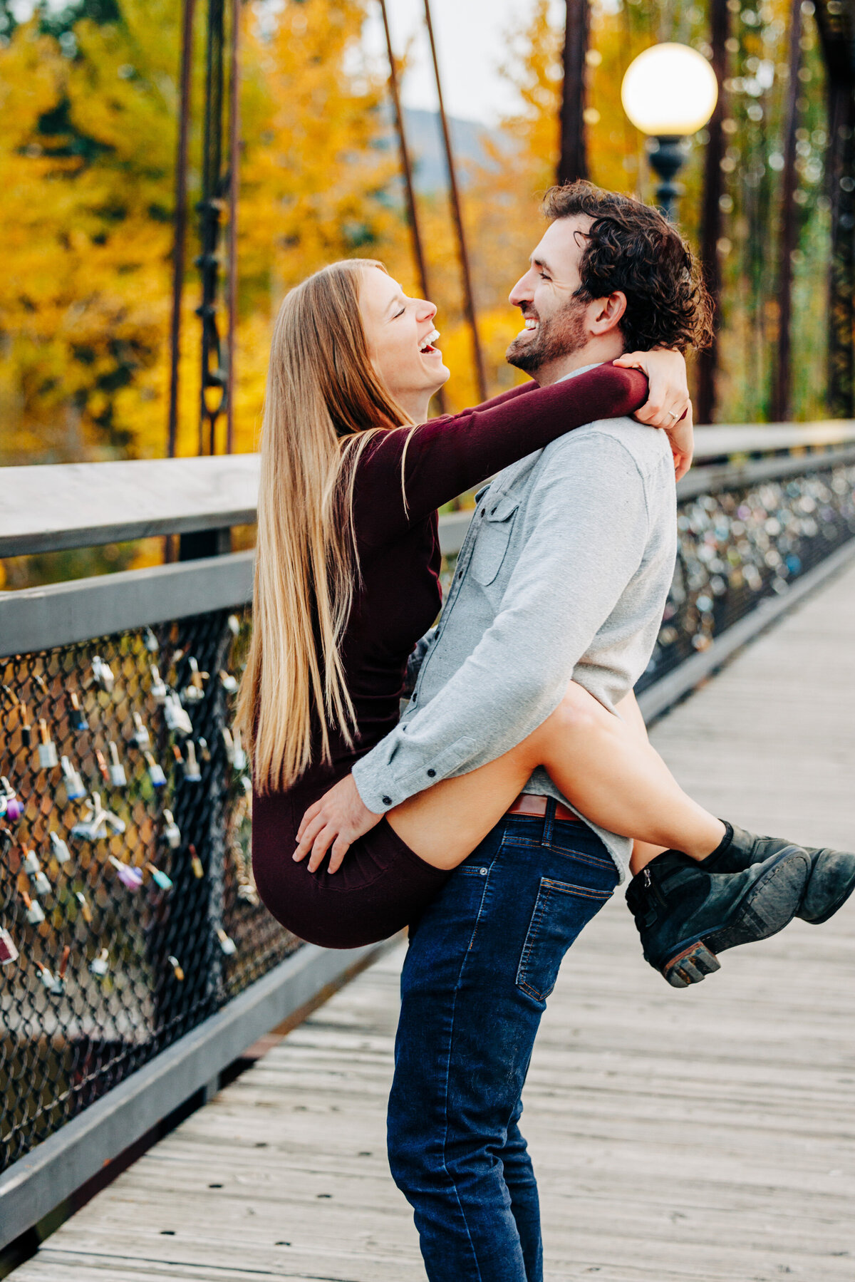 Couple having playful moment on Van Buren Footbridge in Missoula, MT