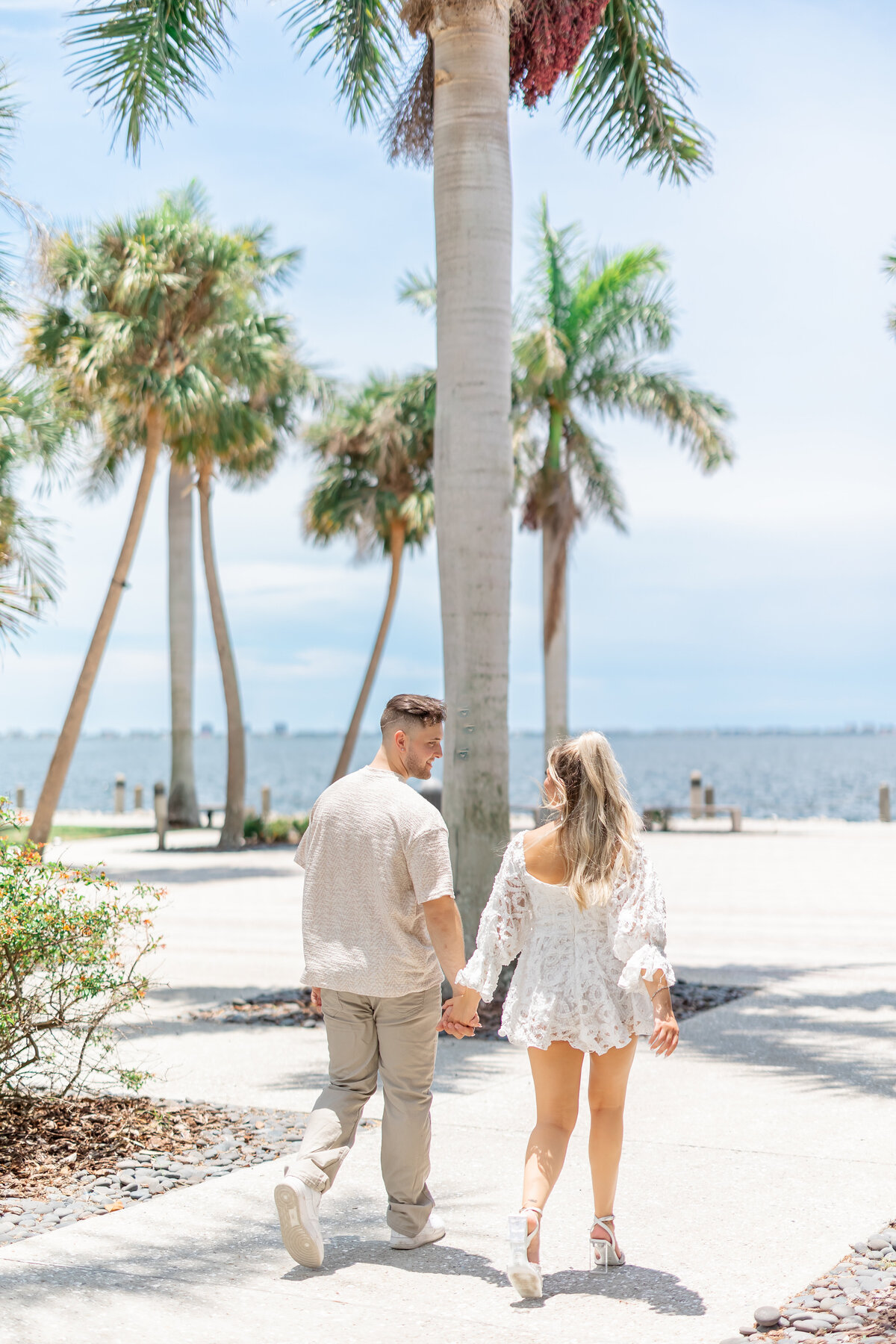 couple holding hands walking by wedding photographer fort lauderdale
