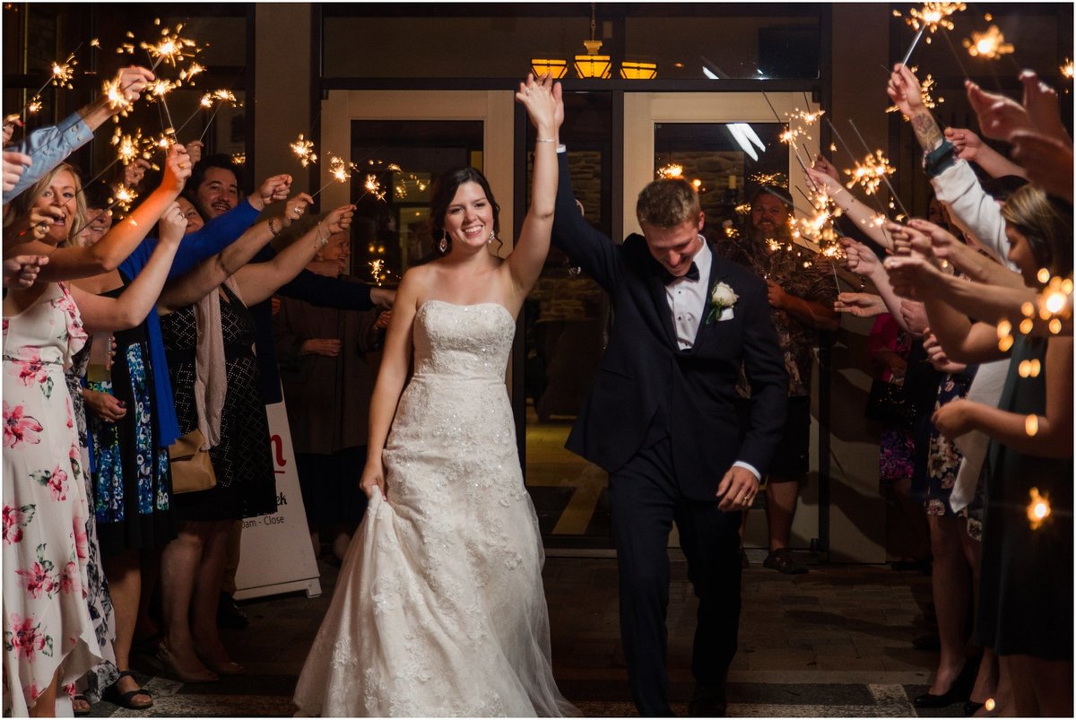 Sparkler exit, bride and groom holding hands