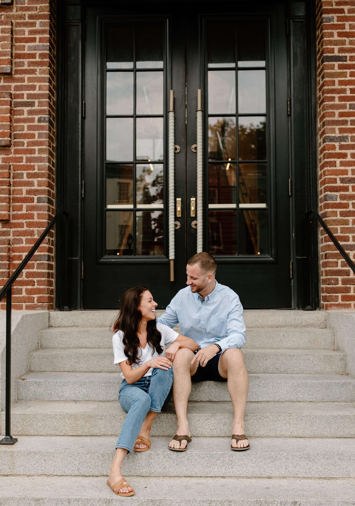couple sitting on steps during engagement session in baltimore maryland casual