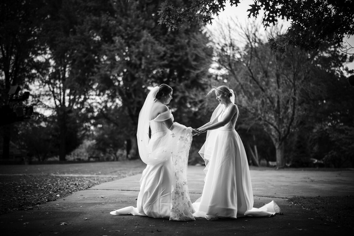 A black and white photo of a first look  at a  Fairmount Park Horticulture Center wedding