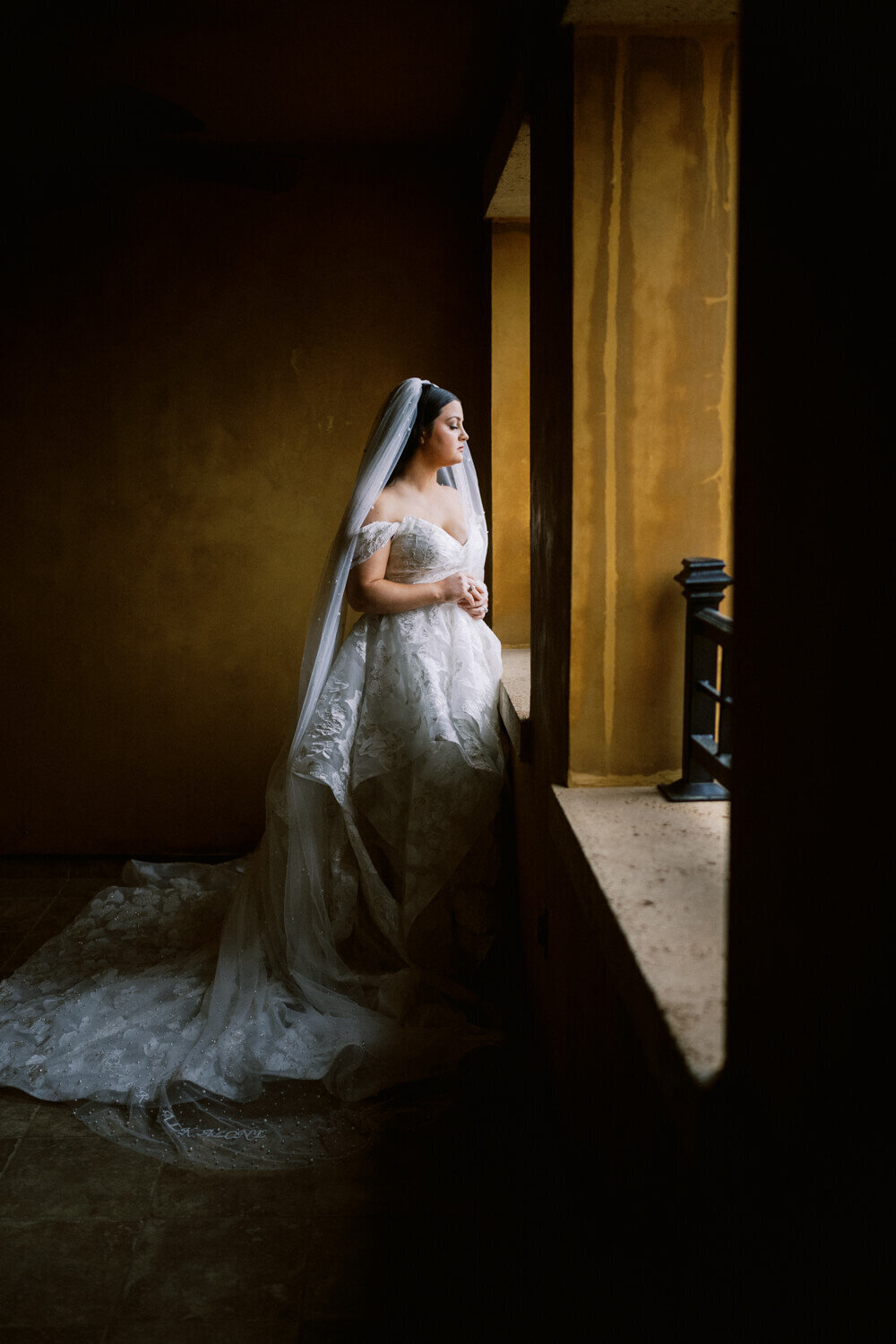 bride-on-stucco-terrace-looking-out