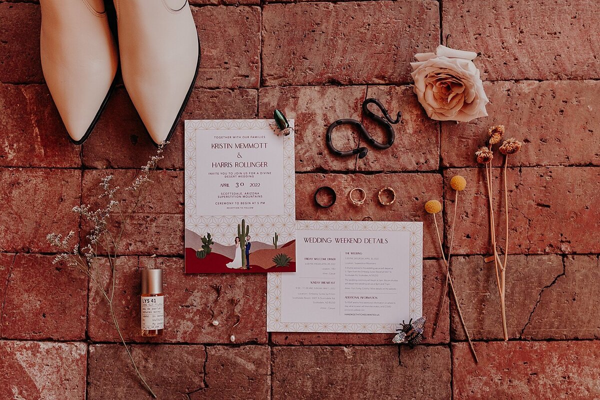 Wedding shoes and invitation and perfume are organized on red brick for a detail photo