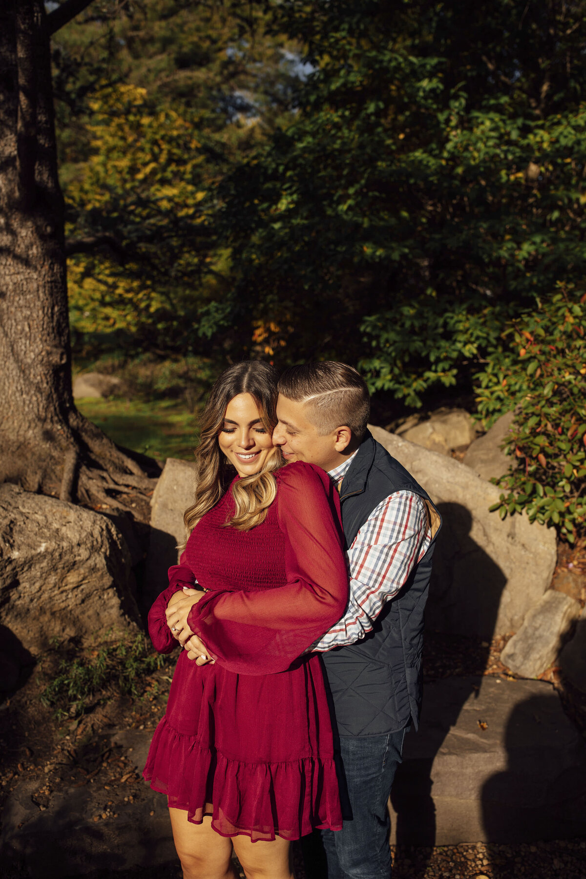 Couple posing in rustic woods during photo session at Sayen House and Gardens in Hamilton Township Mercer County New Jersey