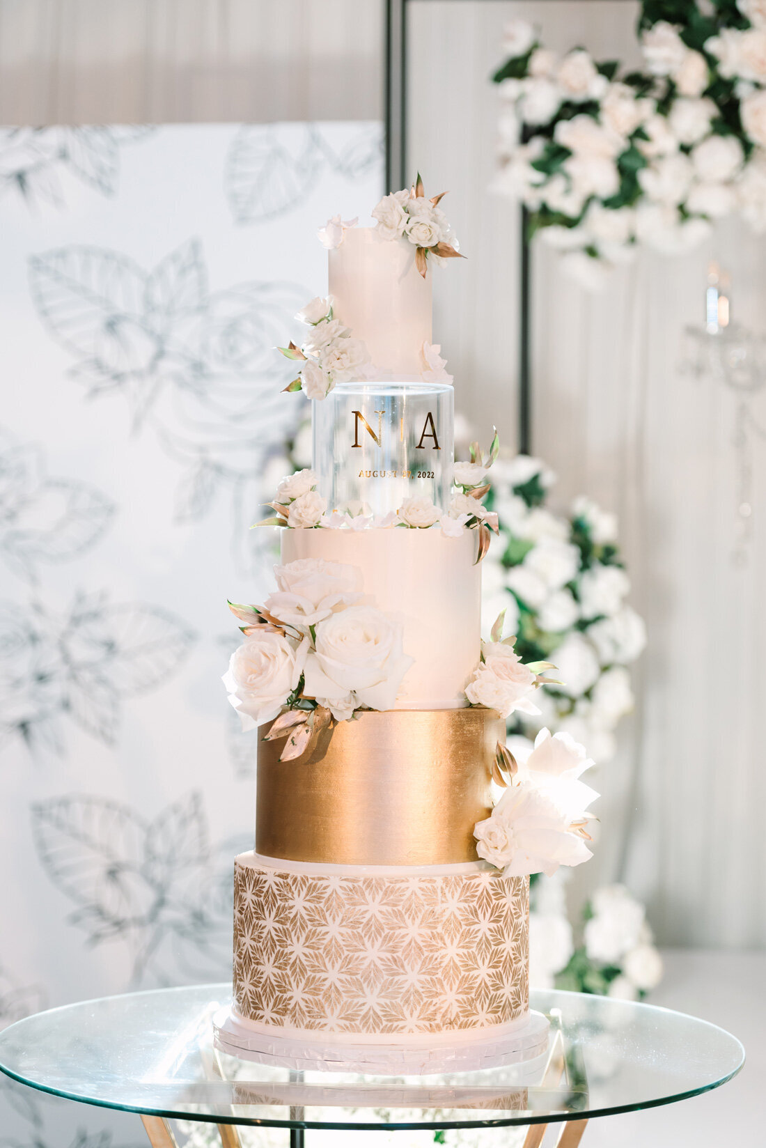 Pink and gold four tiered wedding cake.