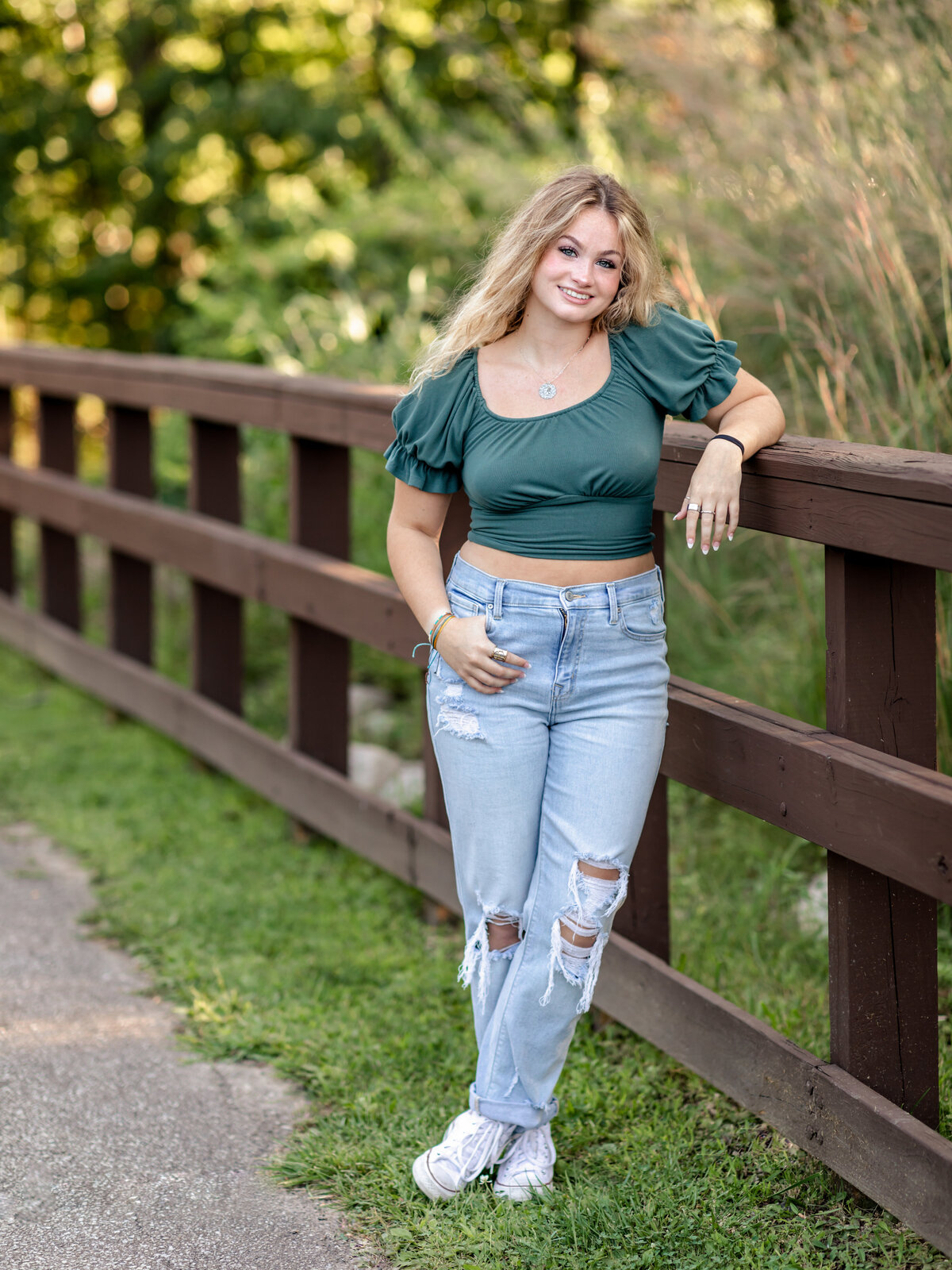 high school senior girl posing for senior portraits at westcreek reservation in parma ohio