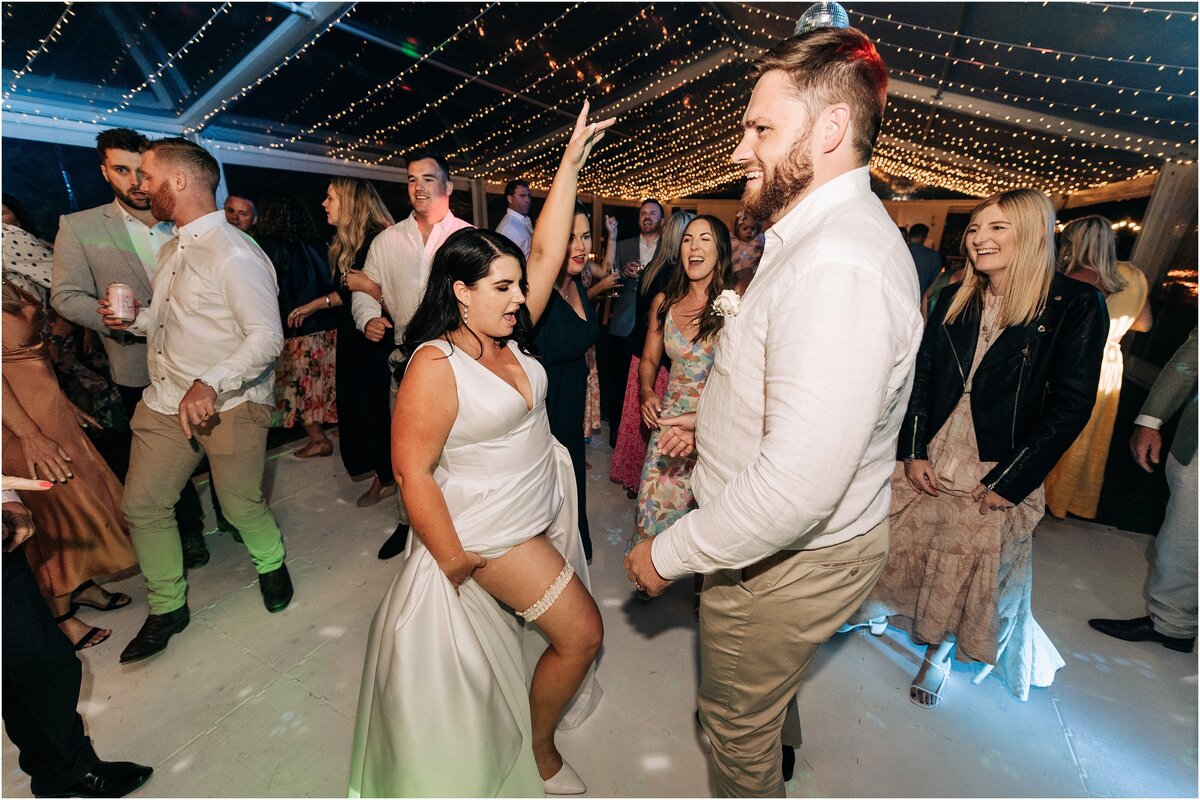 bride and groom on dance floor private venue loula hire christchurch marquee showing leg garter party lighting at night time
