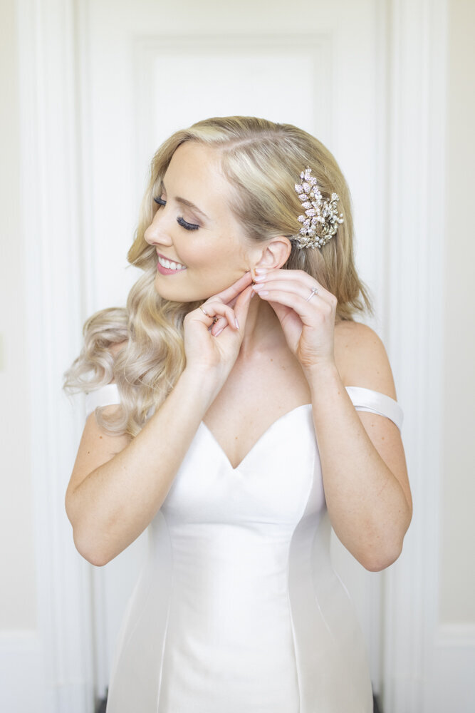 bride putting in earrings - Wadsworth Mansion wedding photographer Rachel Girouard