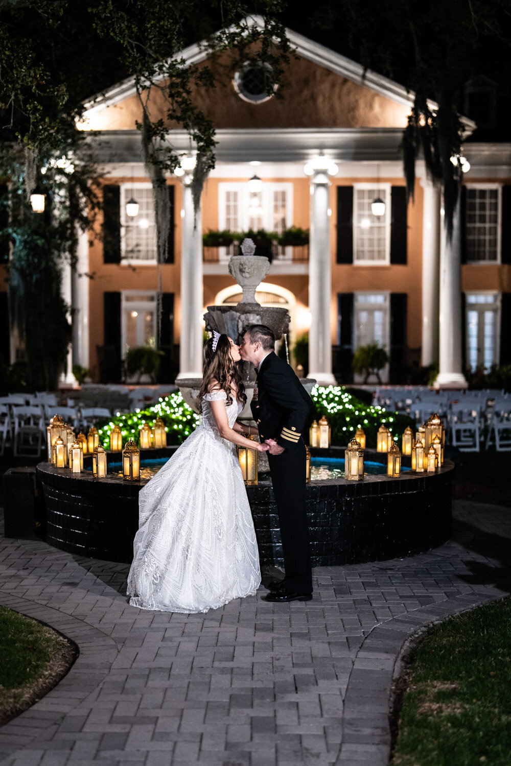 Couple kissing in front of fountain at Southern Oaks