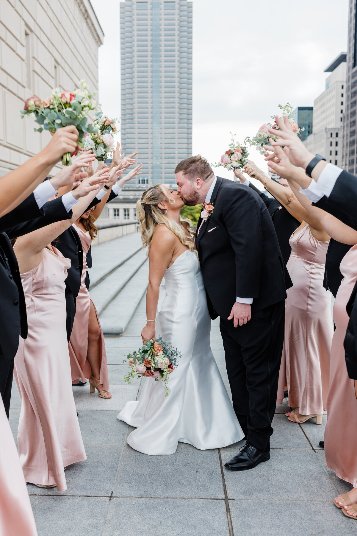Bride and bridesmaids laughing together in pastel dresses at a South Bend wedding.