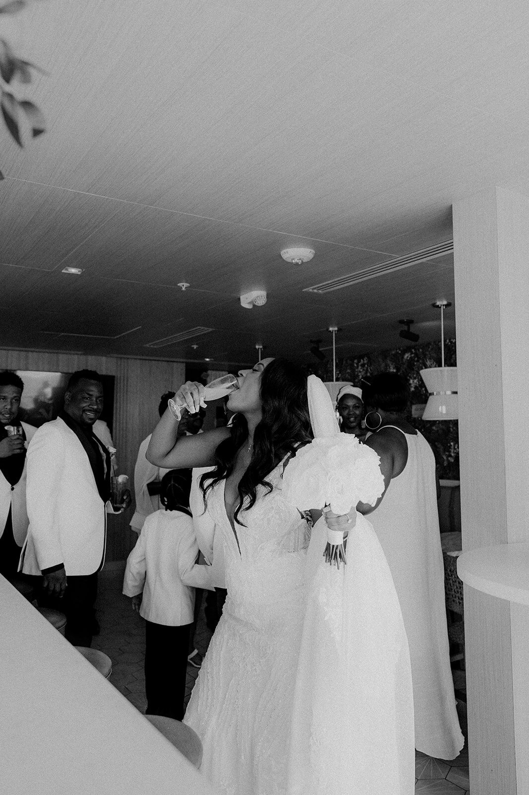 Bride drinking champagne at her San Diego wedding