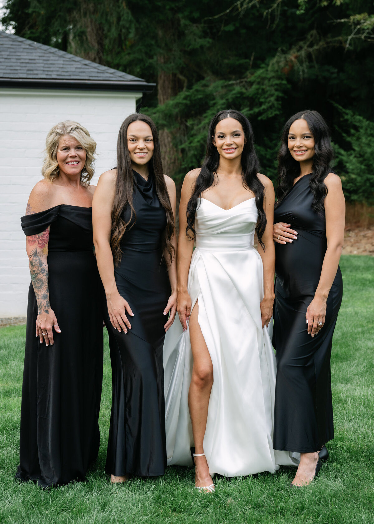 bride with bridesmaids in black gowns