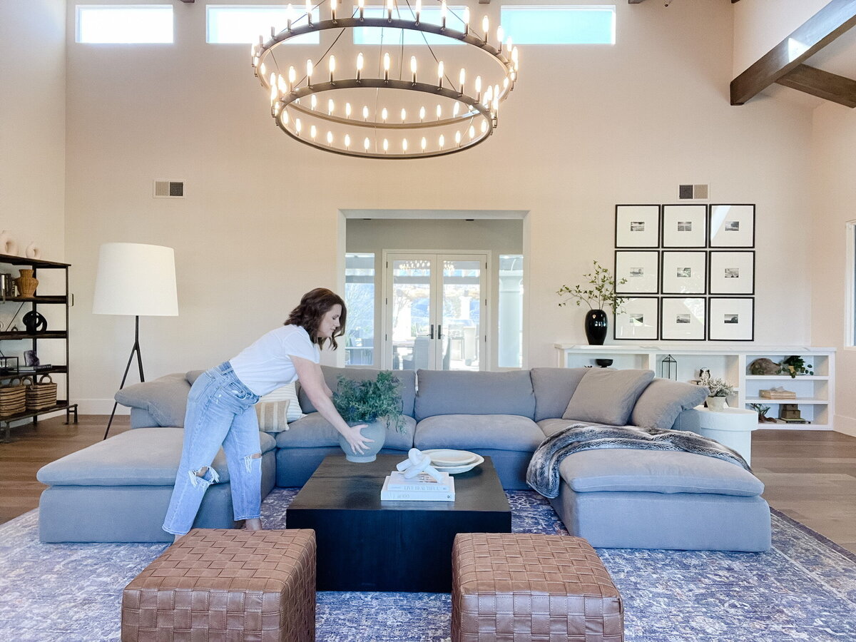 woan arranging pillows on couch