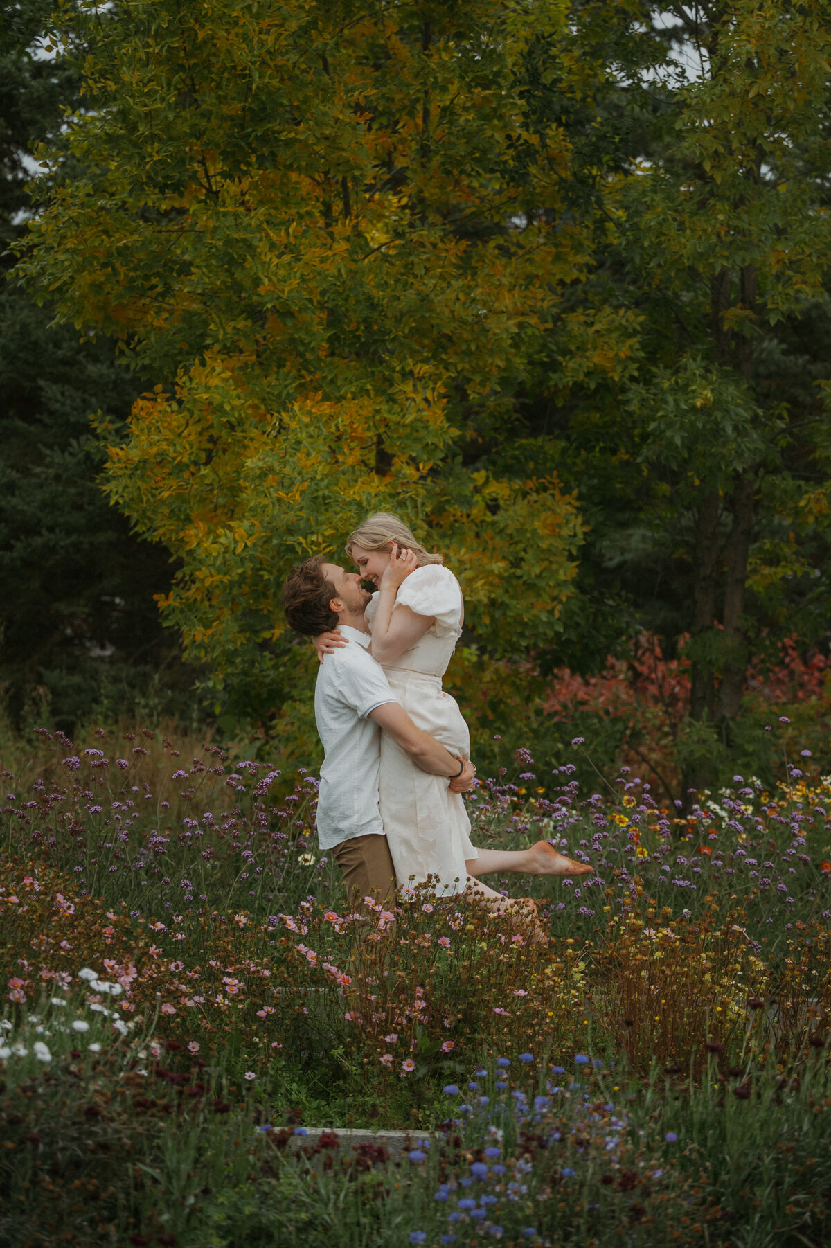 Photograph of couple in a field full of flowers