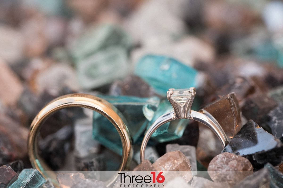 His and Hers Wedding Rings on display together on rocks and stones