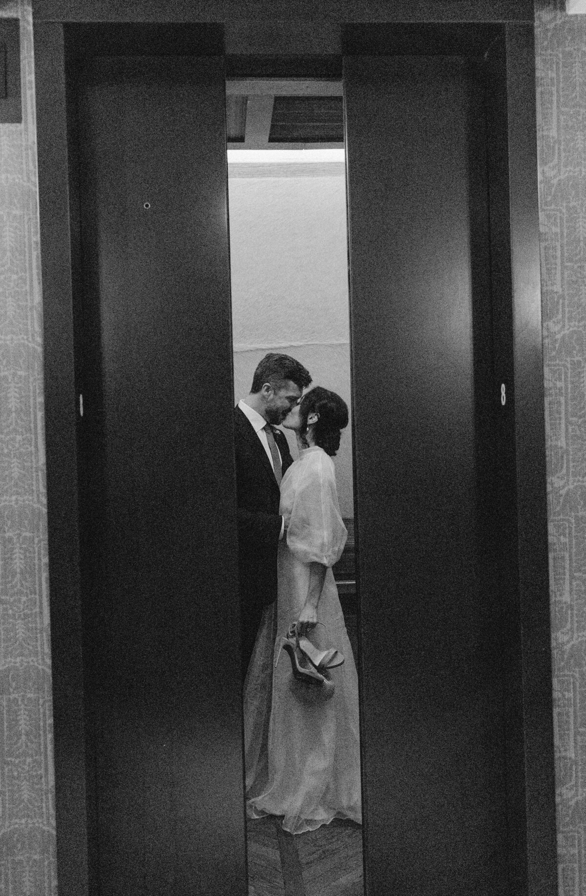 bride and groom pictured in between doors at Proper Hotel Austin