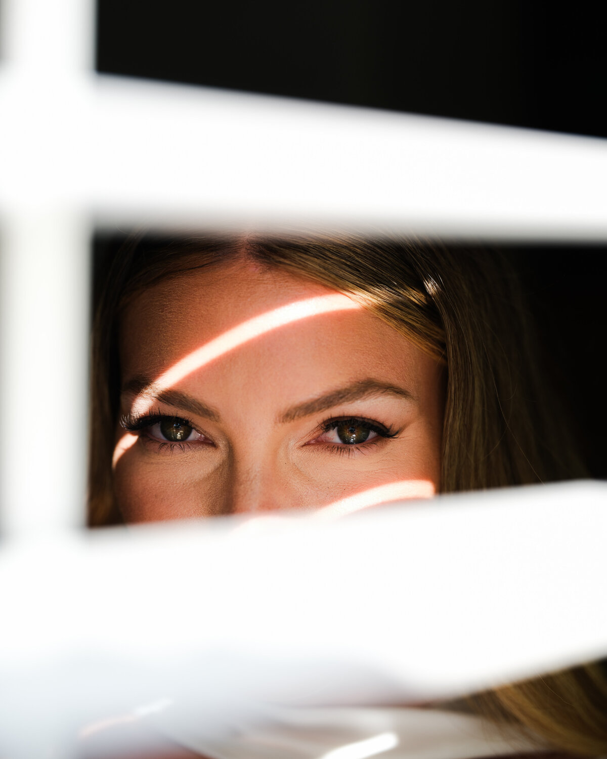 Bride looking through shades with shadows across her face