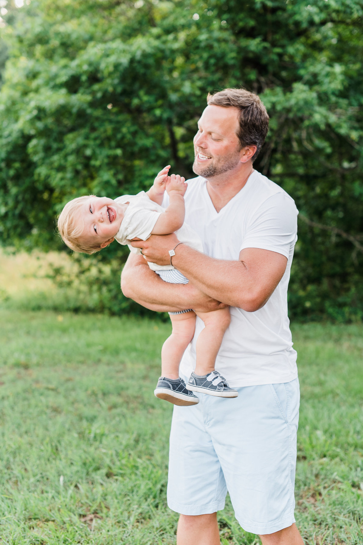 Dad plays with toddler son during a family photography session in Raleigh NC. Photographed by Raleigh NC family photographer A.J. Dunlap Photography.