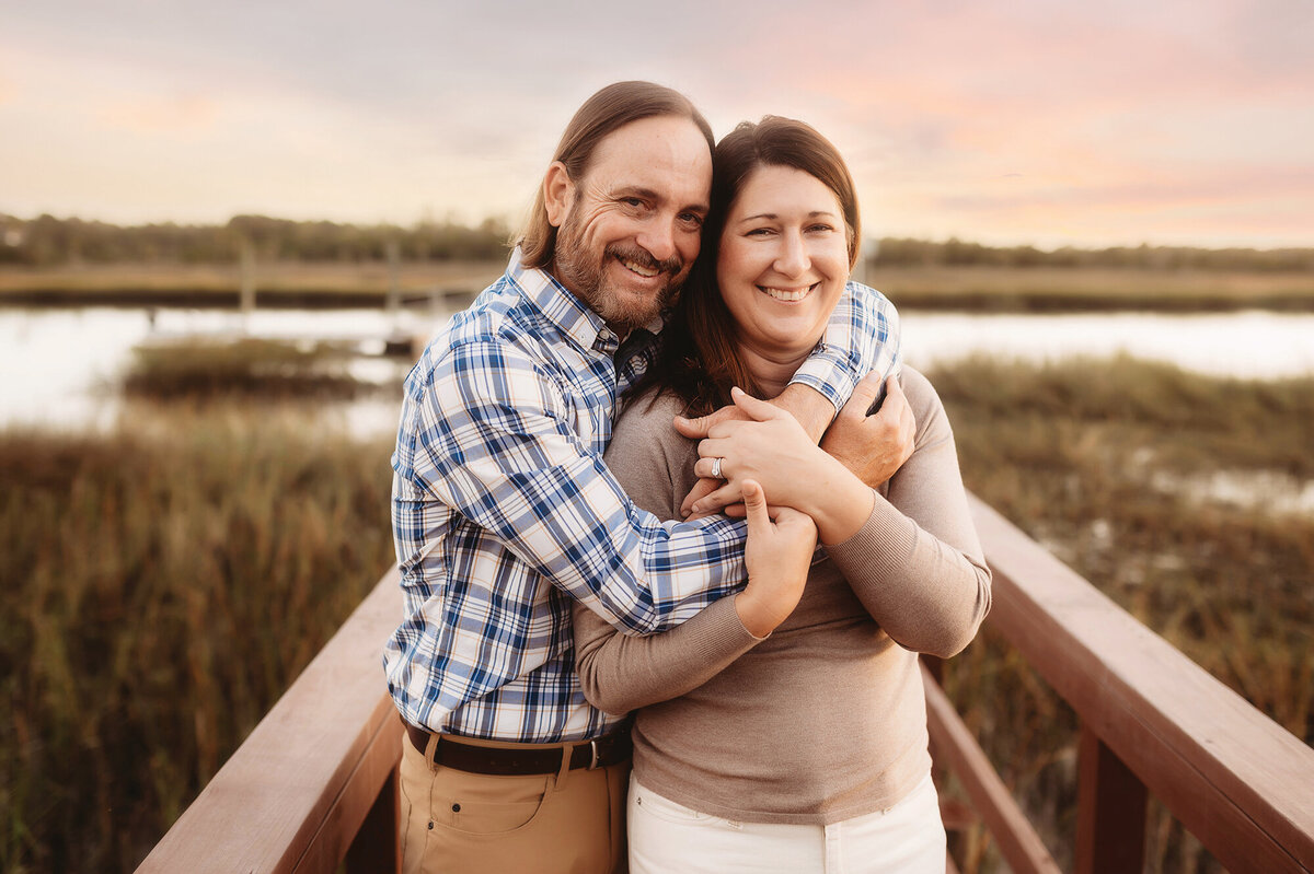 Couple embraces during Family Portrait Session in Charleston, South Caroloina.