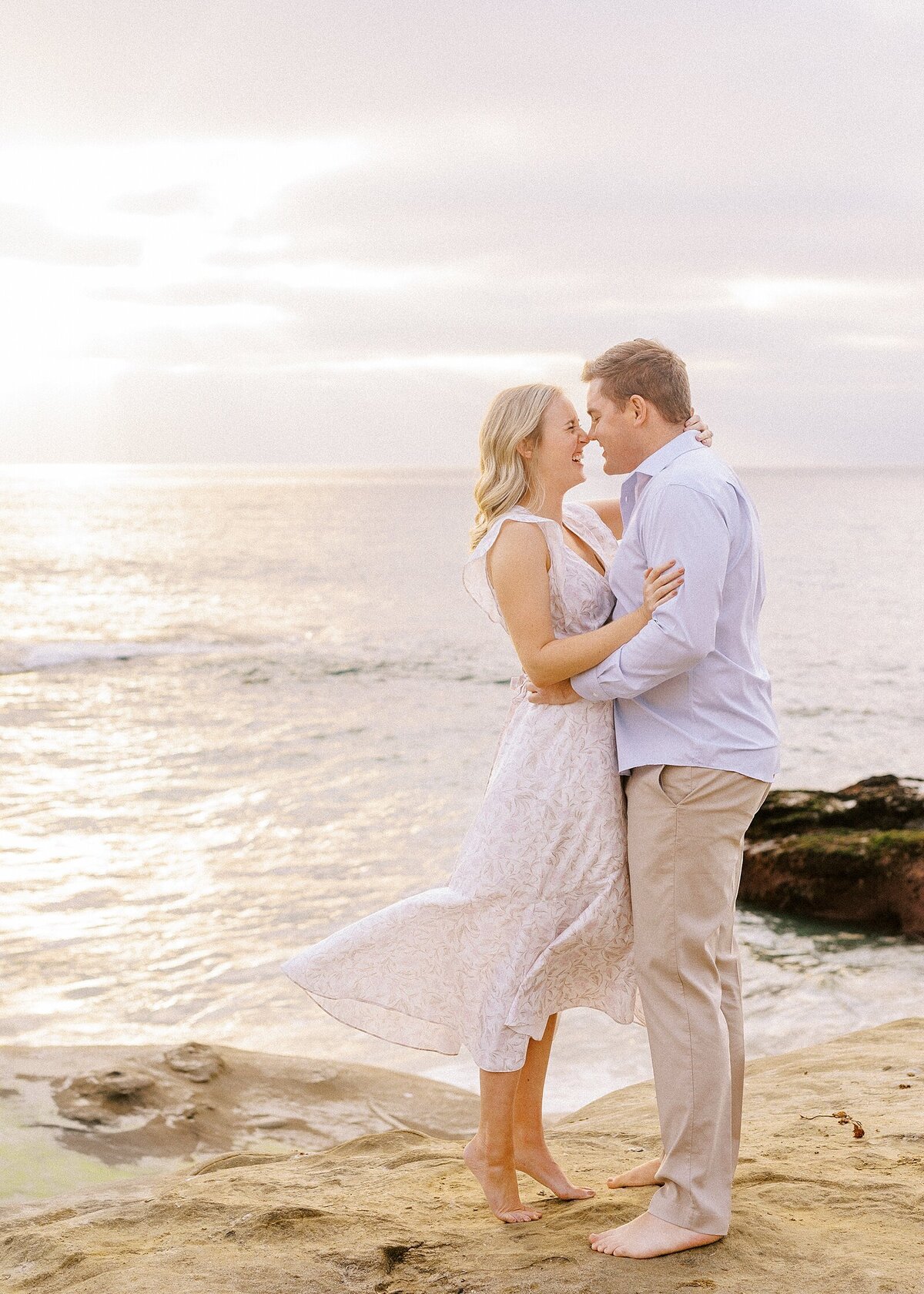 Couple on the coast in Encinitas, California at an engagement session with Lisa Riley.