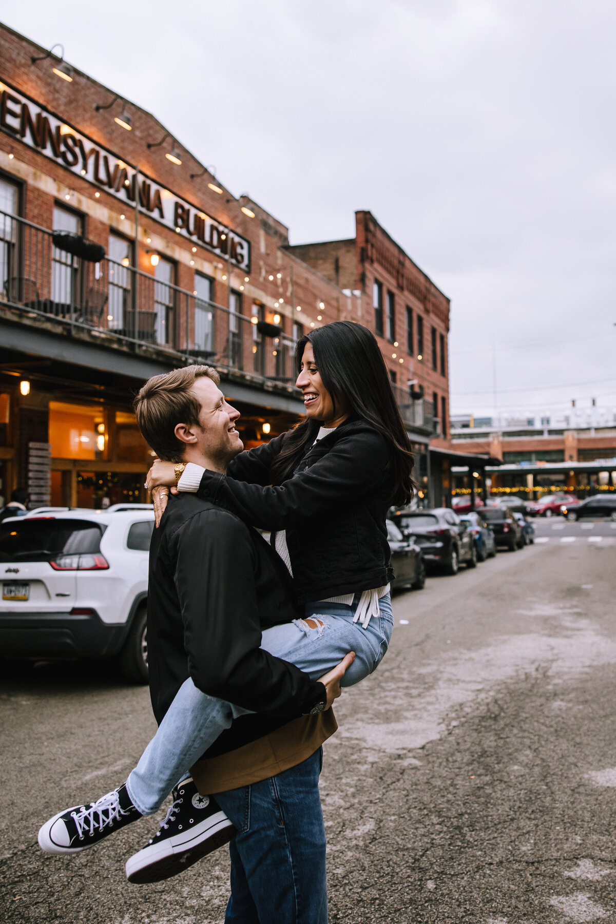 Engaged couple in the strip district of Pittsburgh outside of Pennsylvania Market.