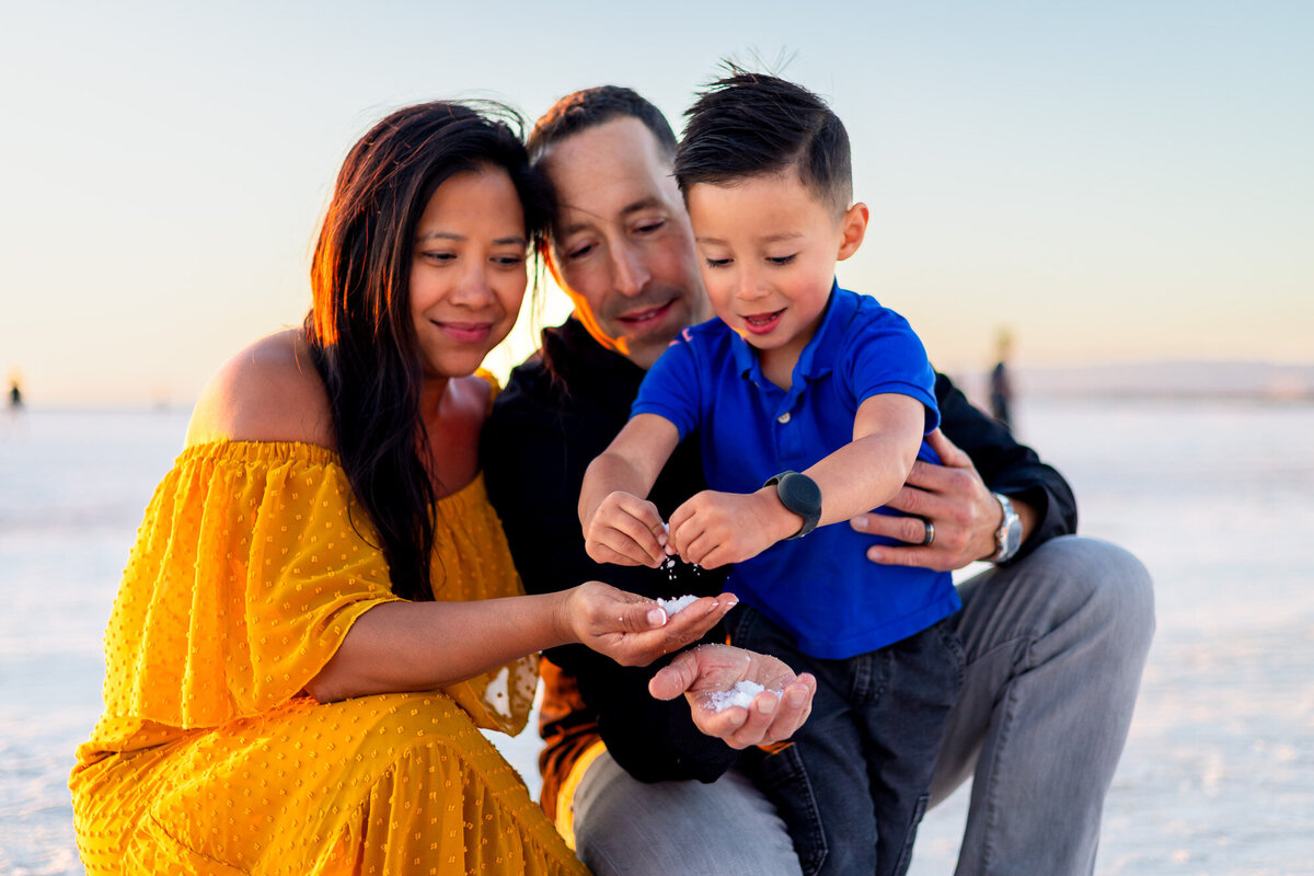 Parents and child smiling and playing with salt crystals at sunset – Bay Area Family Portfolio - Ellobelle Photography
