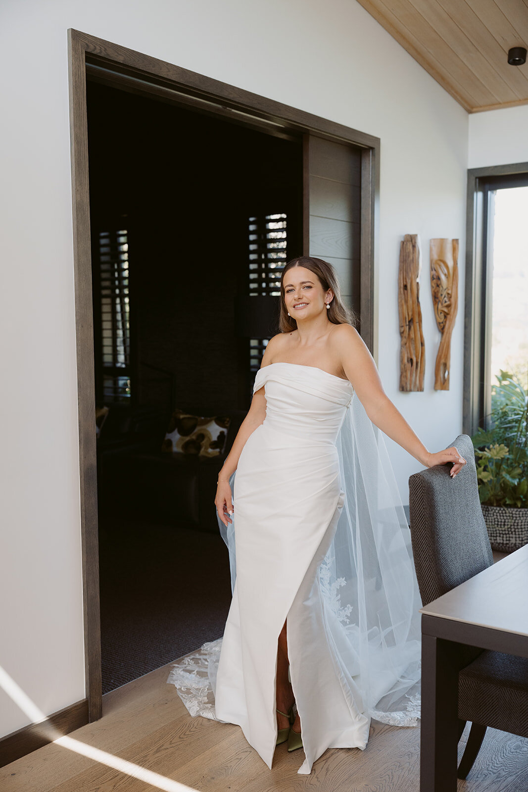 bride on wedding morning smiling with hair and makeup professionally done