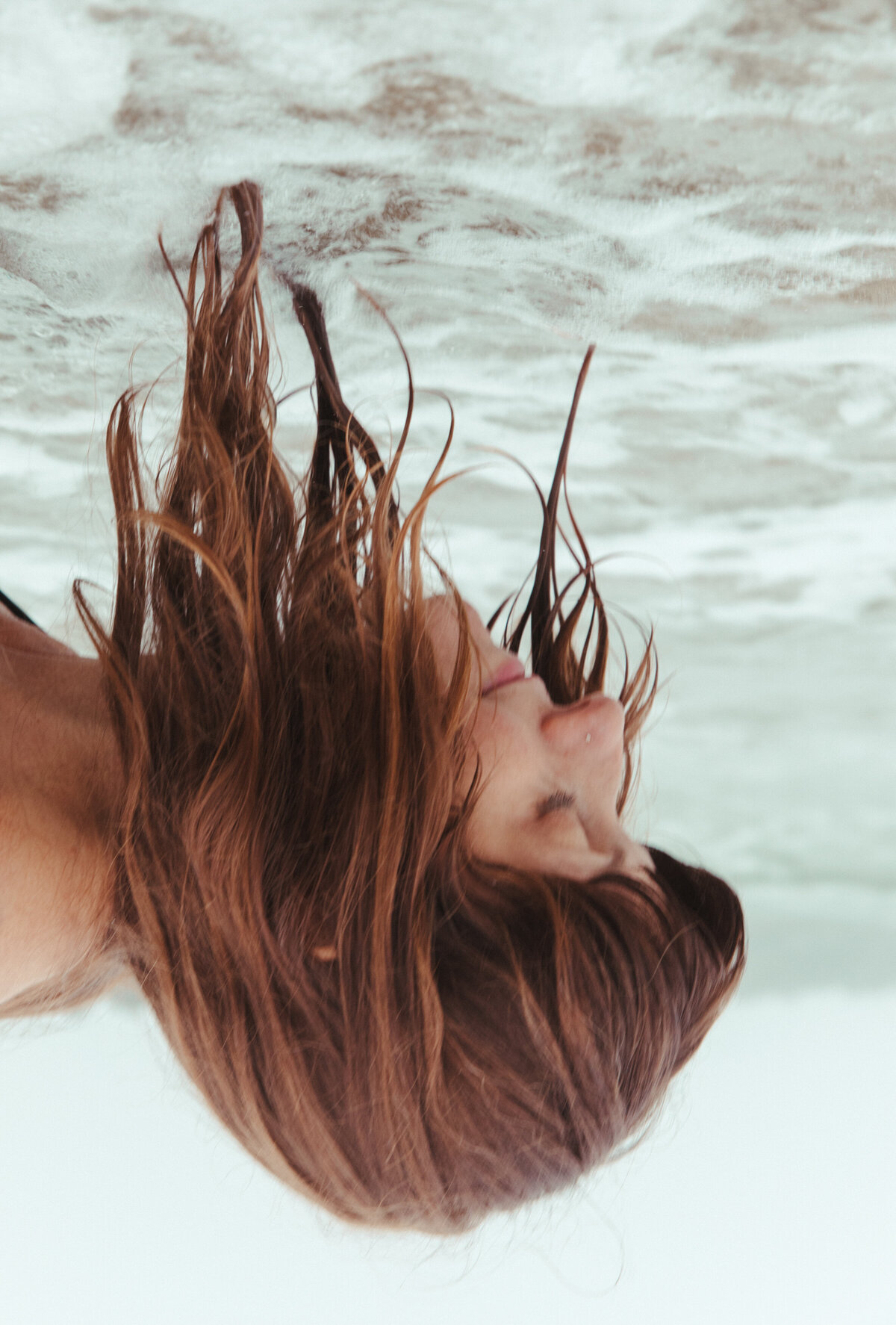Woman in the ocean at the Oregon Coast by Portland photographer Karen Pride.