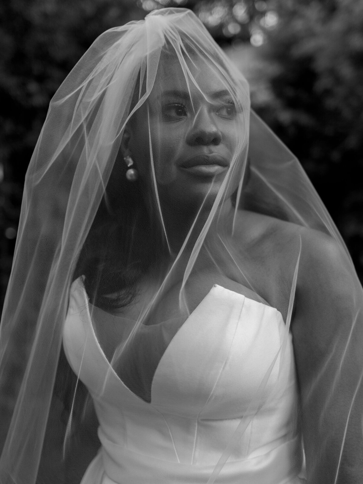 stunning portrait captured by erich mcvey of a beautiful black bride in a custom bridal gown and veil. posing in san francisco california at a private venue.