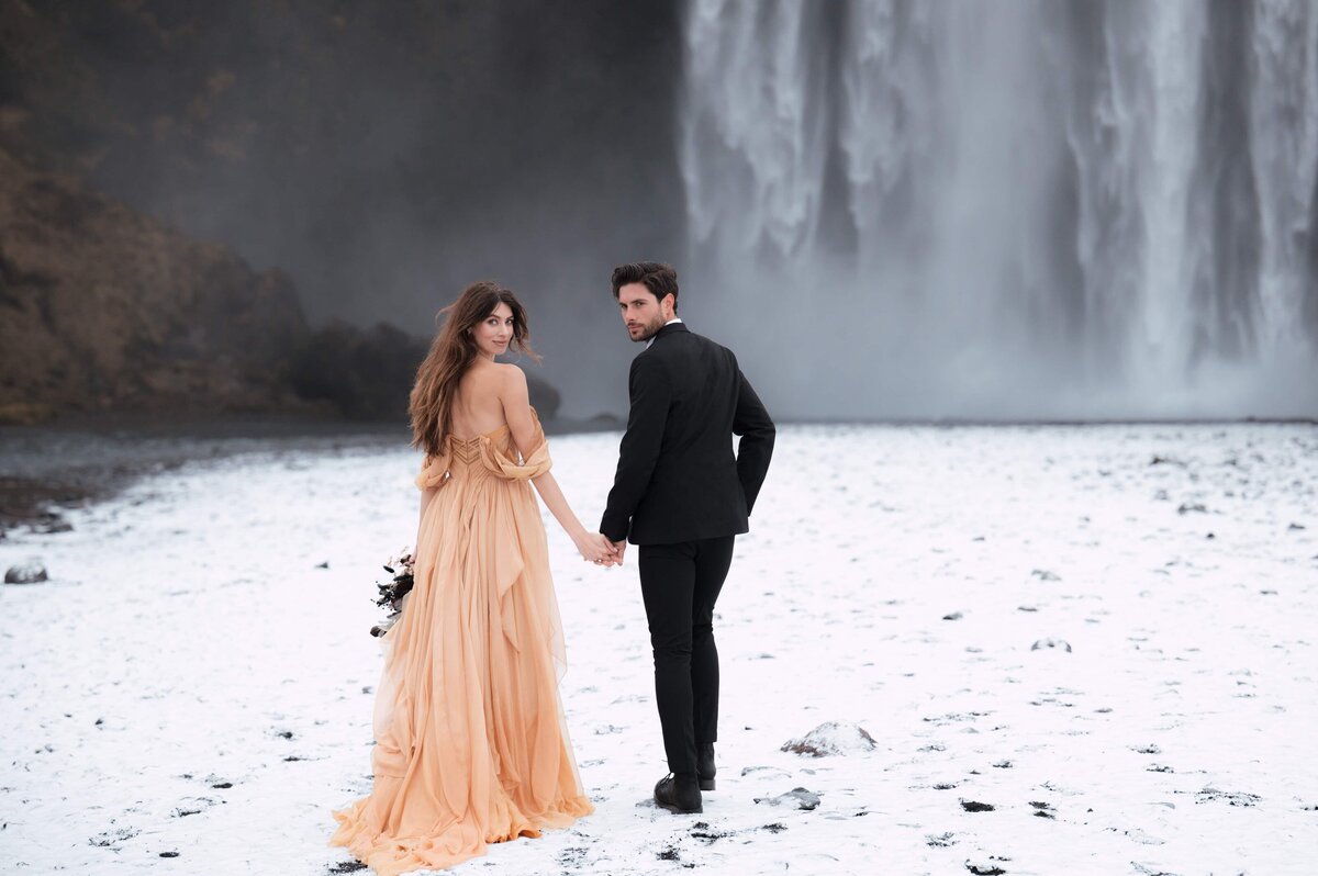 Beneath the crashing waters of Skógafoss, a couple holds onto what matters most—each other.
