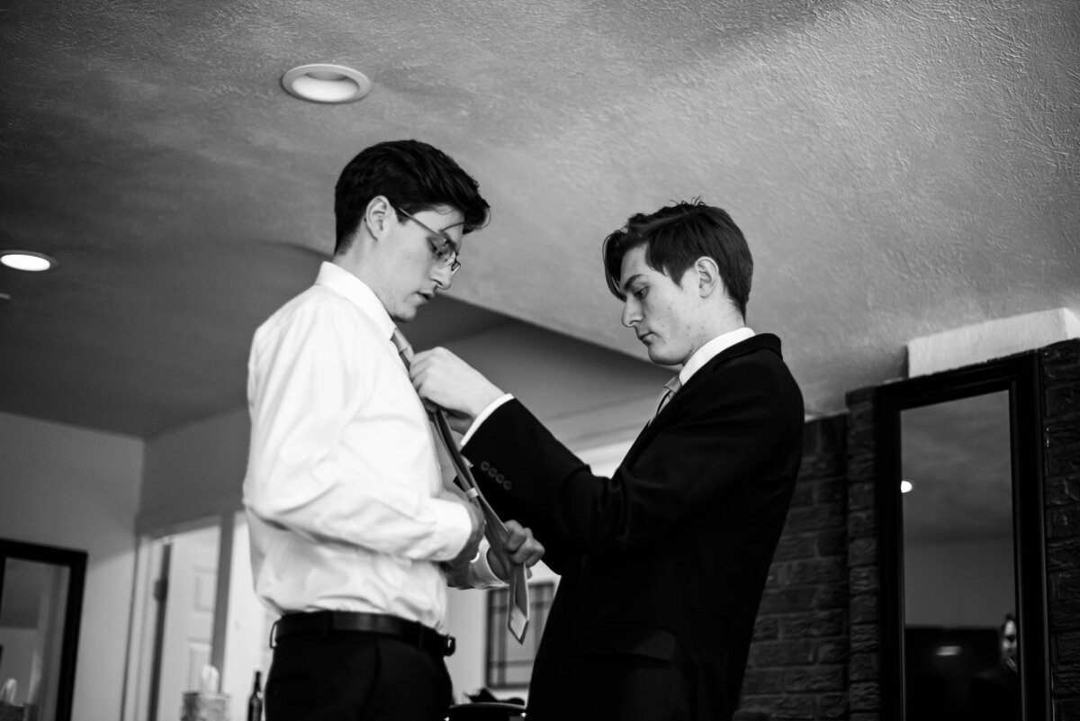 Best Man helps groom get ready for his wedding at Wedgewood Boulder