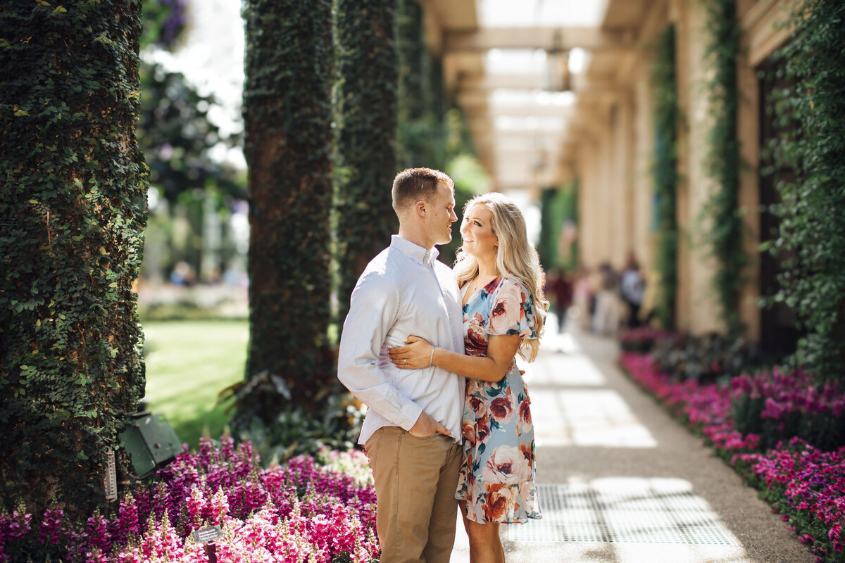 Longwood Gardens Pre-Wedding Photos | Couple Hugging Near Ivy and Flowers | Kennett Square, Pennsylvania