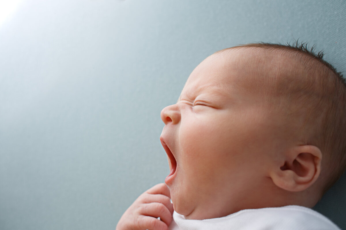 Closeup of a  yawning newborn baby's face