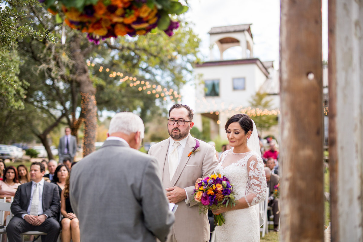 couple during outdoor wedding ceremony facing officiant at marquadt ranch venue.