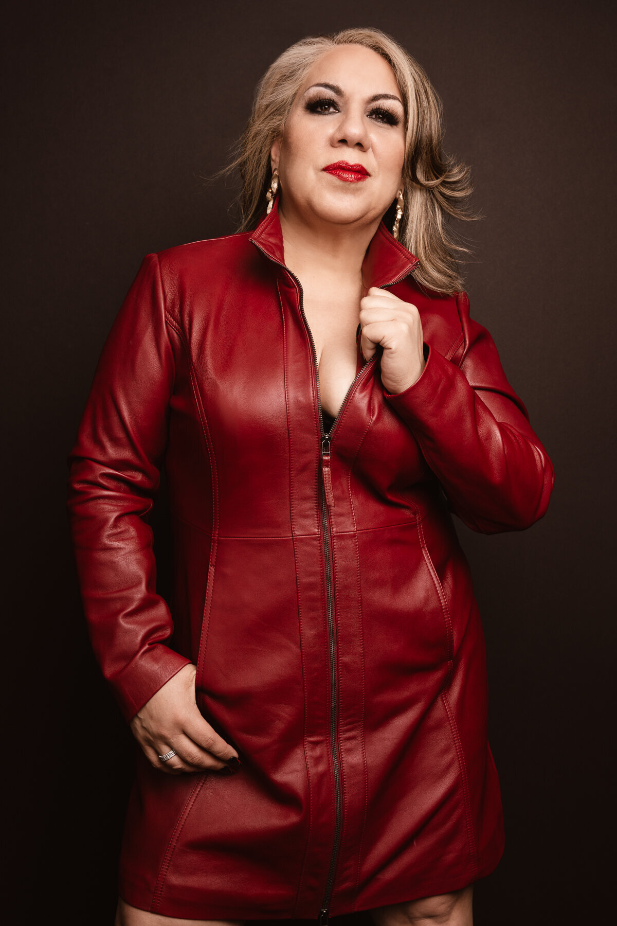 Picture of a mature beautiful woman in a leather red dress