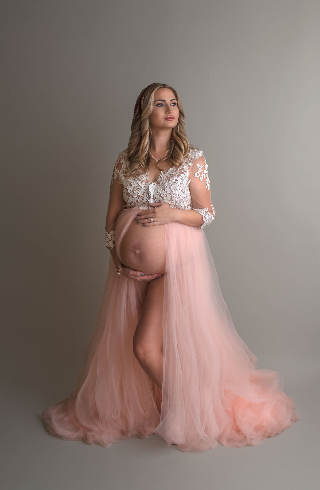 pregnant woman in pink and lace gown