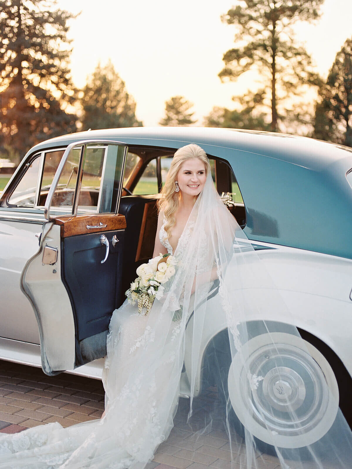 Bride stepping out of a classic car
