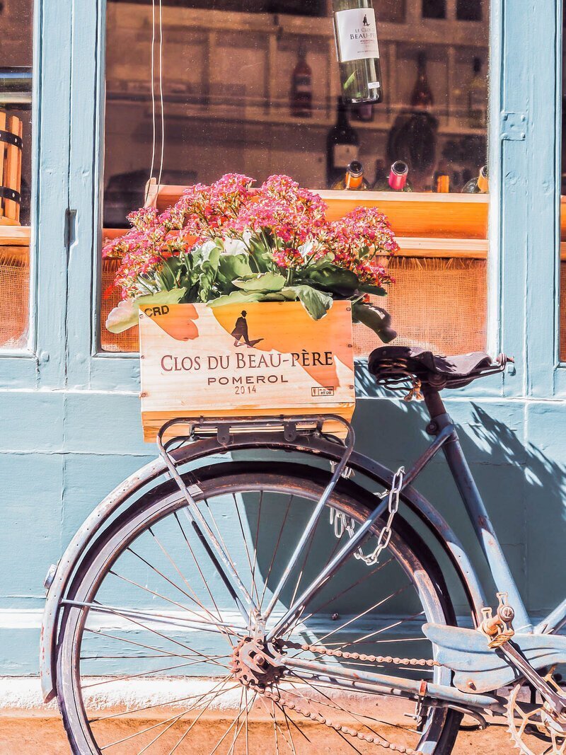 Bicycle with flowers near window on a trip planned by personal vacation planner GG Mack