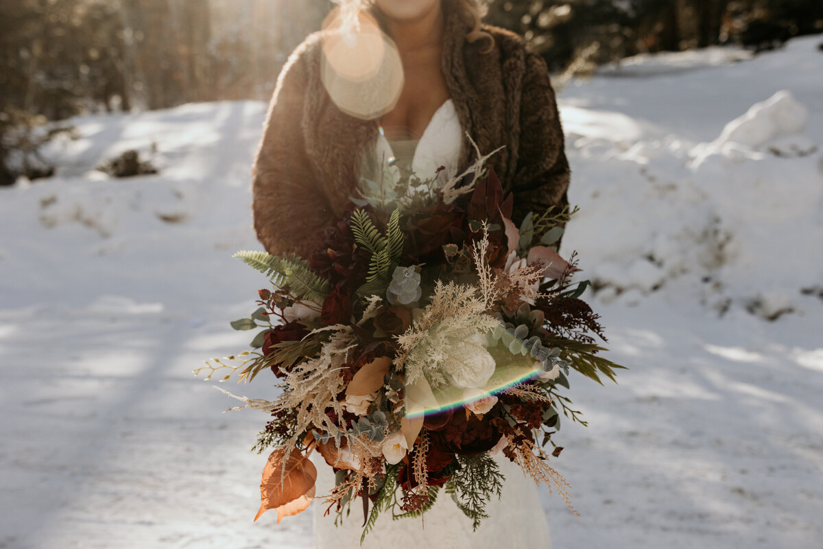 bride standing in the snow in Angel Fire, new Mexico