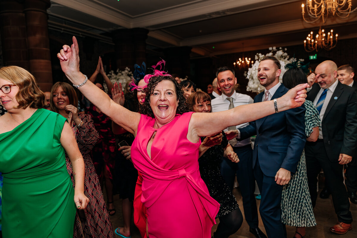 Lady in pink dress partying at wedding 