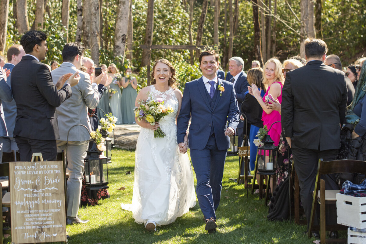 Couple walking down wedding aisle at Hawkesdene