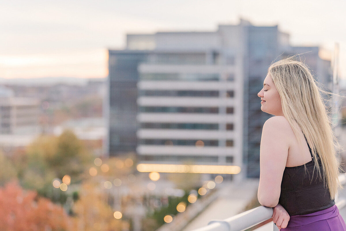 girl looking over rooftop taken by a Vienna, VA senior photographer