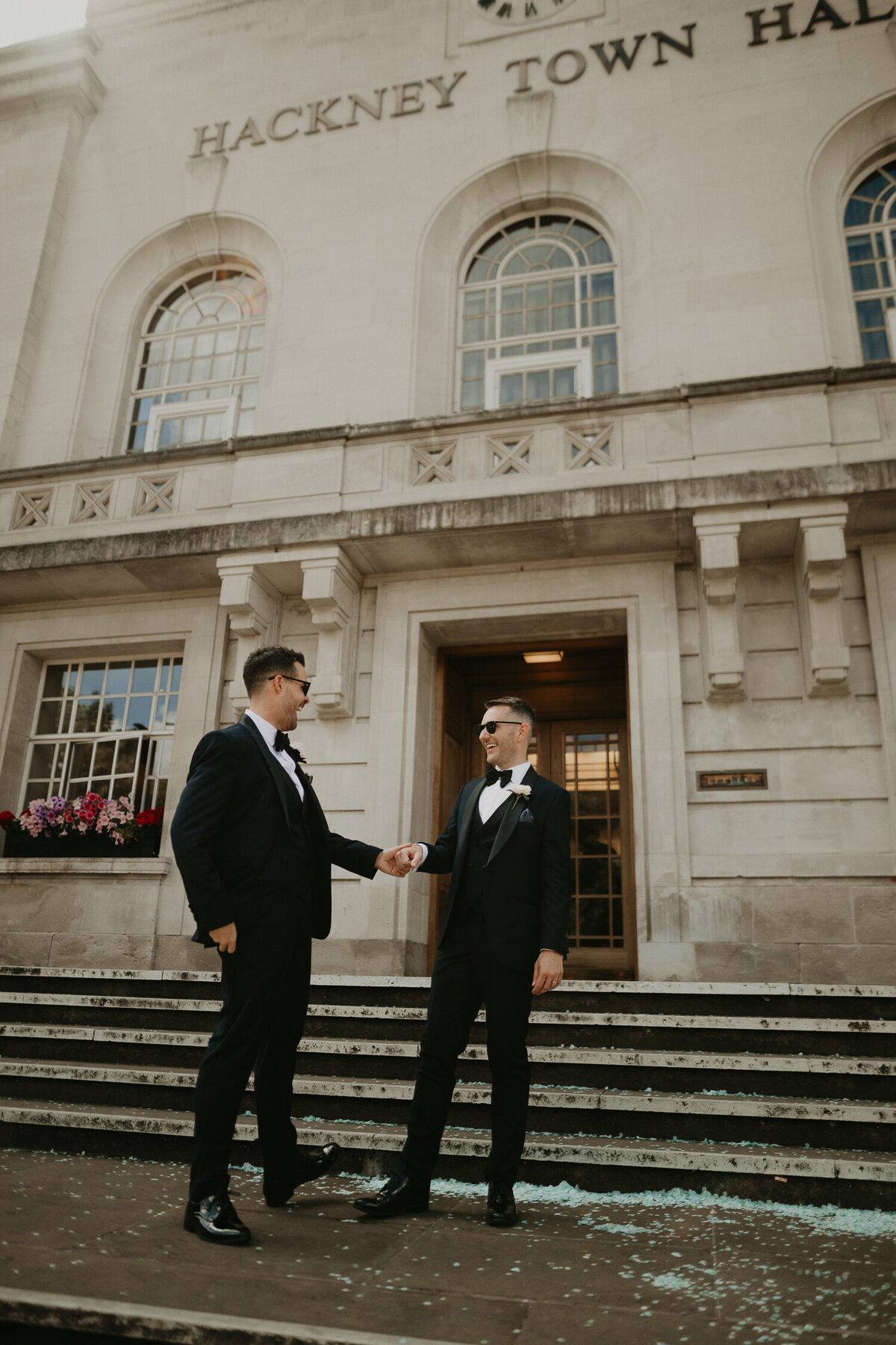 Two grooms on the stairs of Hackney Town Hall.