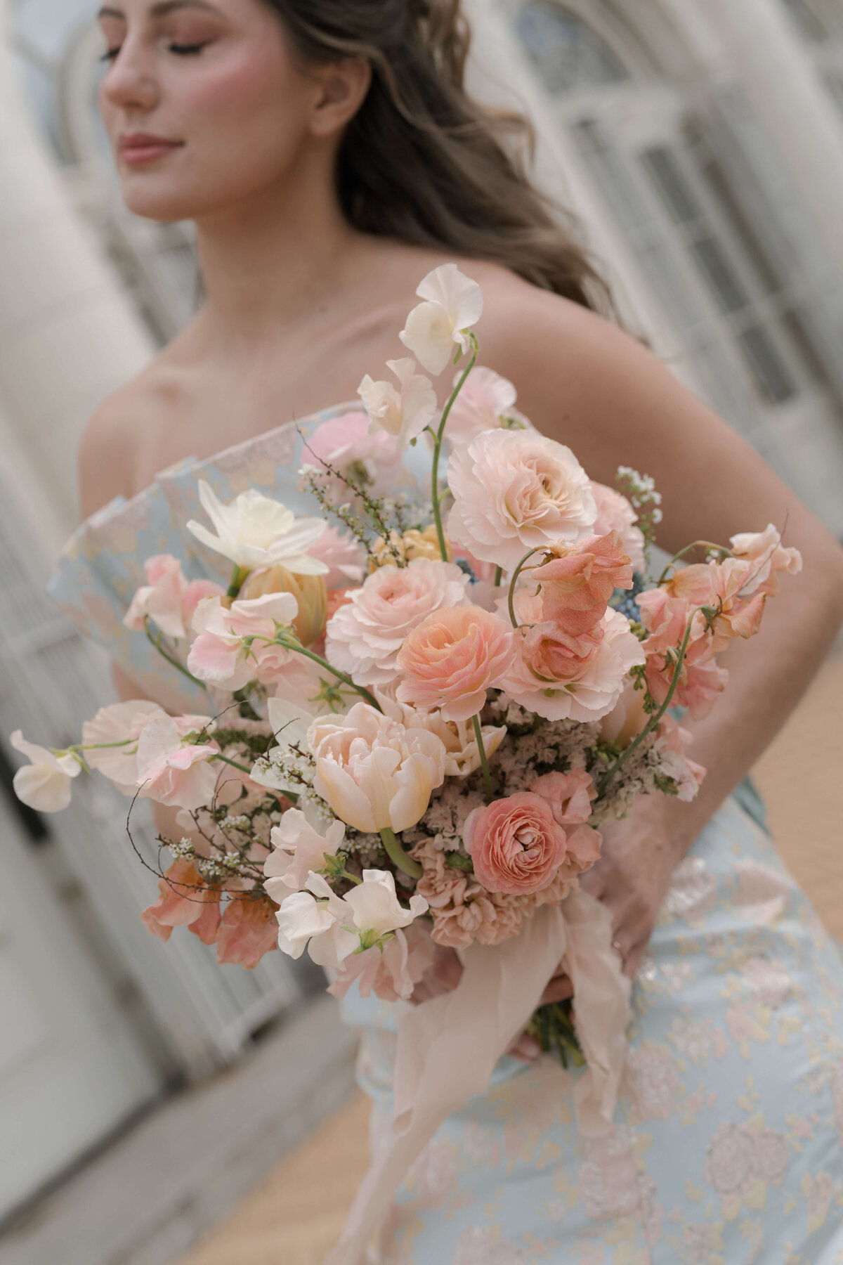 bride holding bridal bouquet at angle