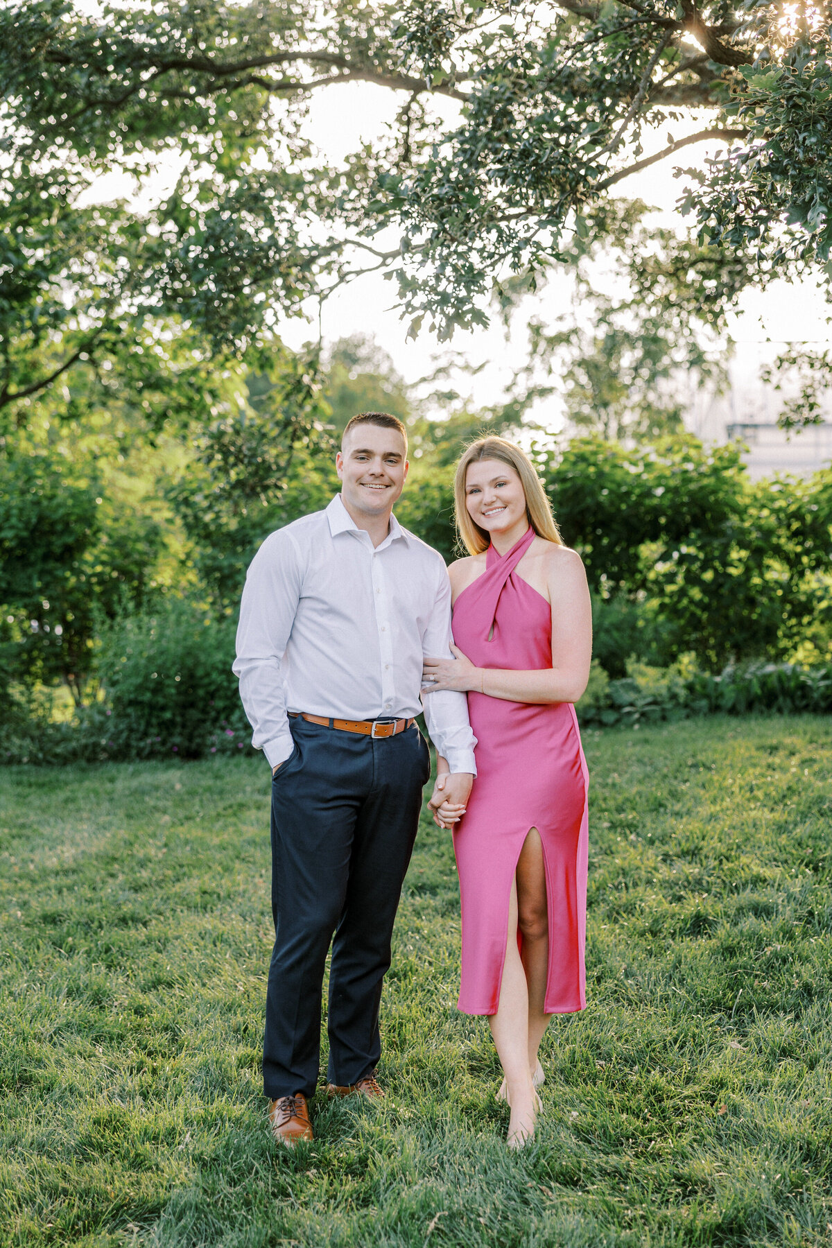Smiling couple shares a moment during sunny engagement session in Columbus, Ohio.