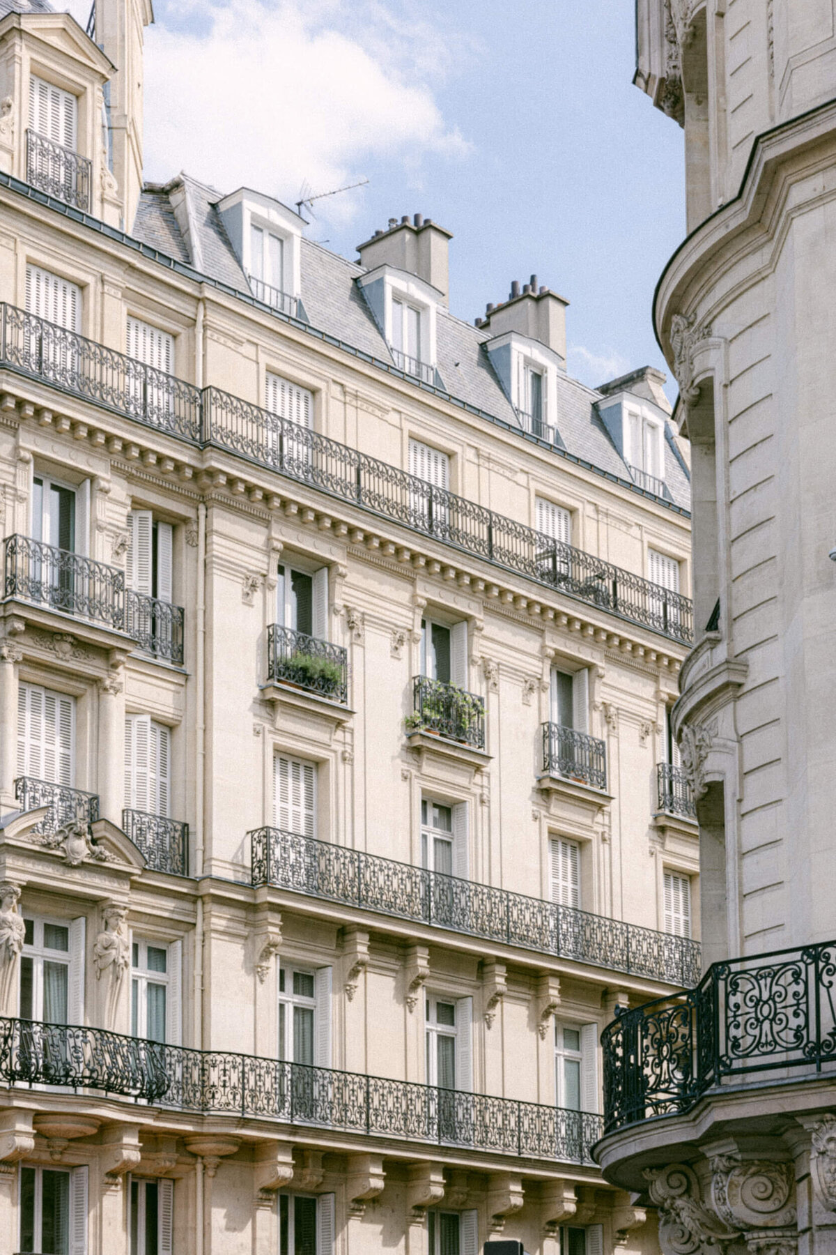 A wedding photo of a bride in her white dress in the streets of Paris in France.