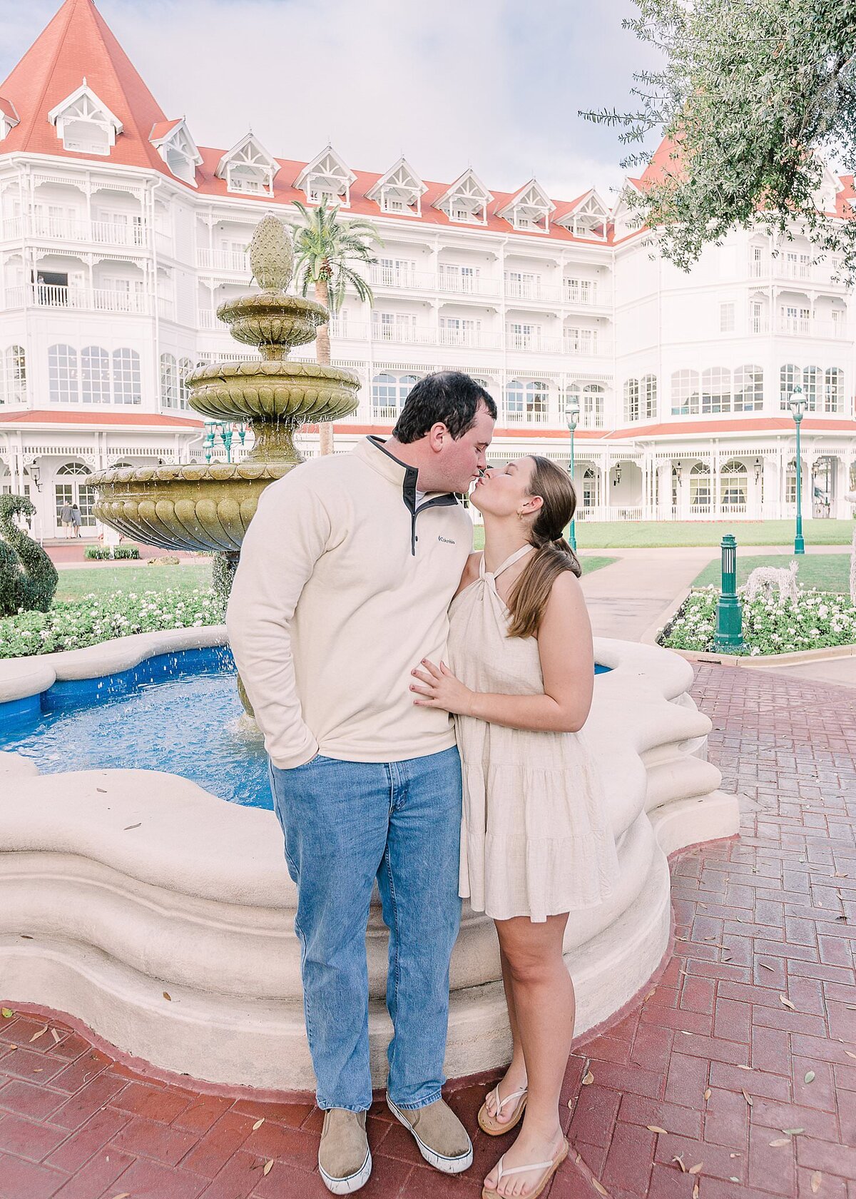 Couple kissing in front of a fountain at Disney's Grand Floridian Resort, in love