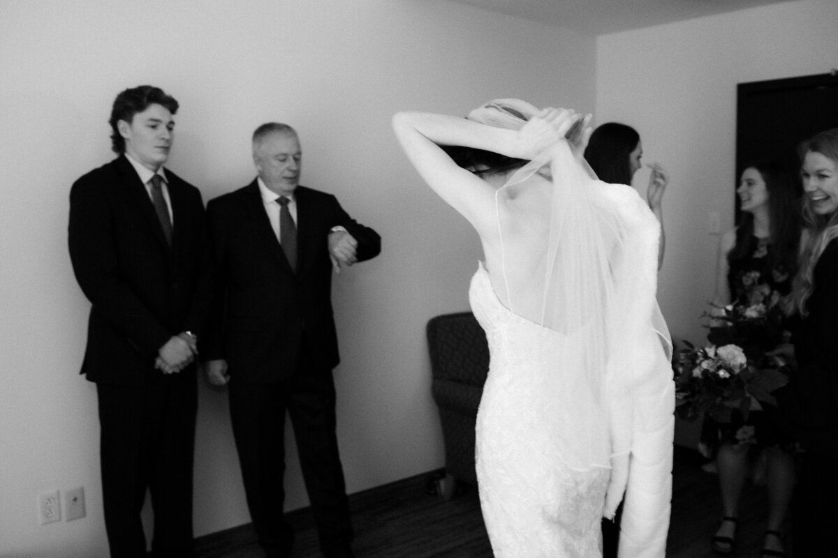 black and white image of a bride with her family before the ceremony